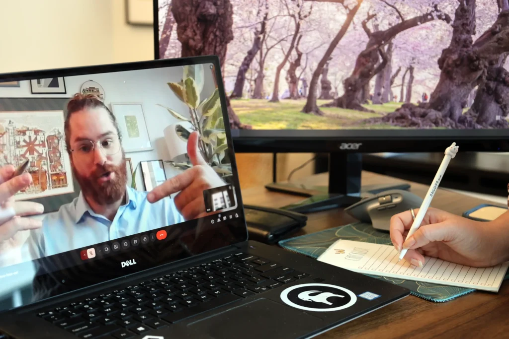 Client taking notes during a travel planning consultation video call with Origins of Adventure